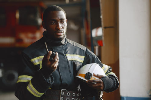 Firefighter in gear performing an inspection