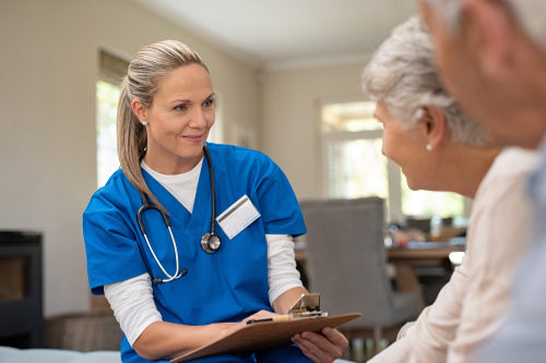 Nurse talking to senior patients in private clinic