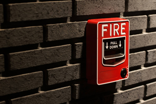 Fire alarm switch on a brick wall