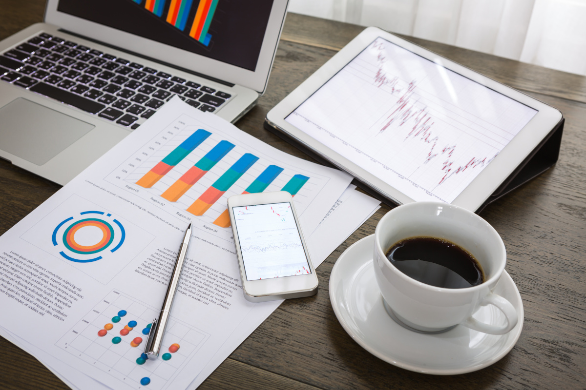 Business desk with tablet, phone, documents and a cup of coffee